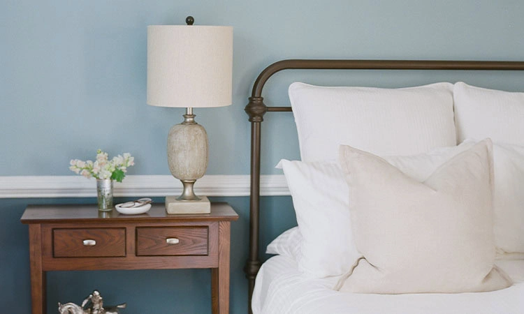 Cozy Bedroom at The Red Fox Inn & Tavern Elegant bedroom with white bedding, wooden nightstand, and soft blue walls.