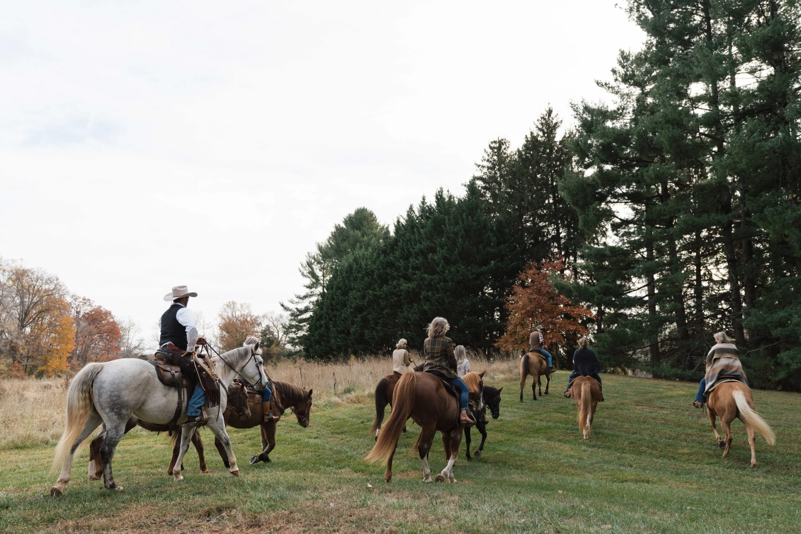 Horseback riding, autumn scenery, outdoor activity, scenic retreat, fall foliage.