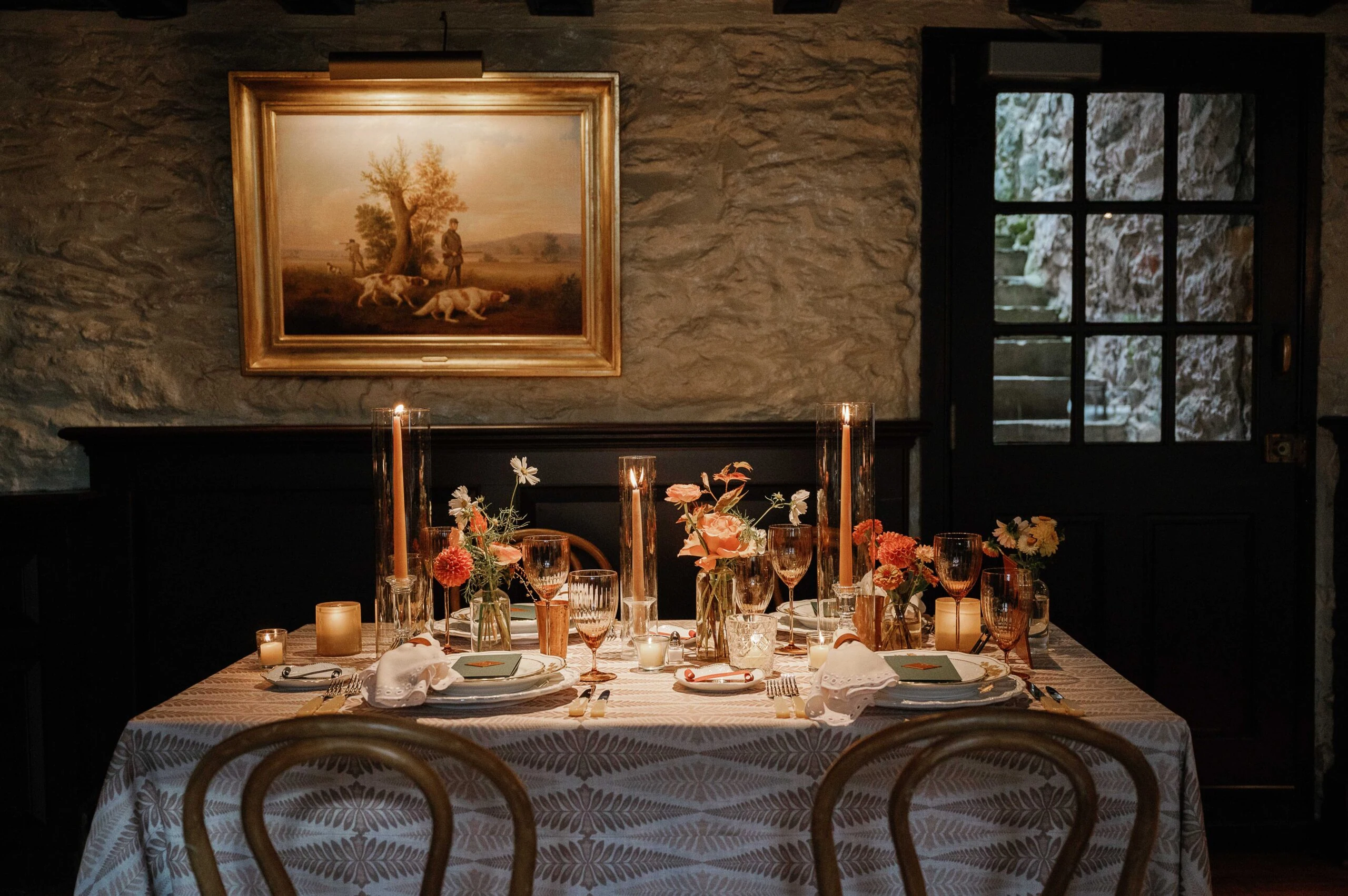 Elegant wedding reception table with floral arrangements and candles at The Red Fox Inn & Tavern.