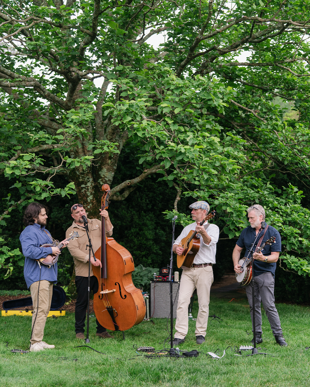 Live band playing acoustic music outdoors at The Red Fox Inn & Tavern during Parade Party.