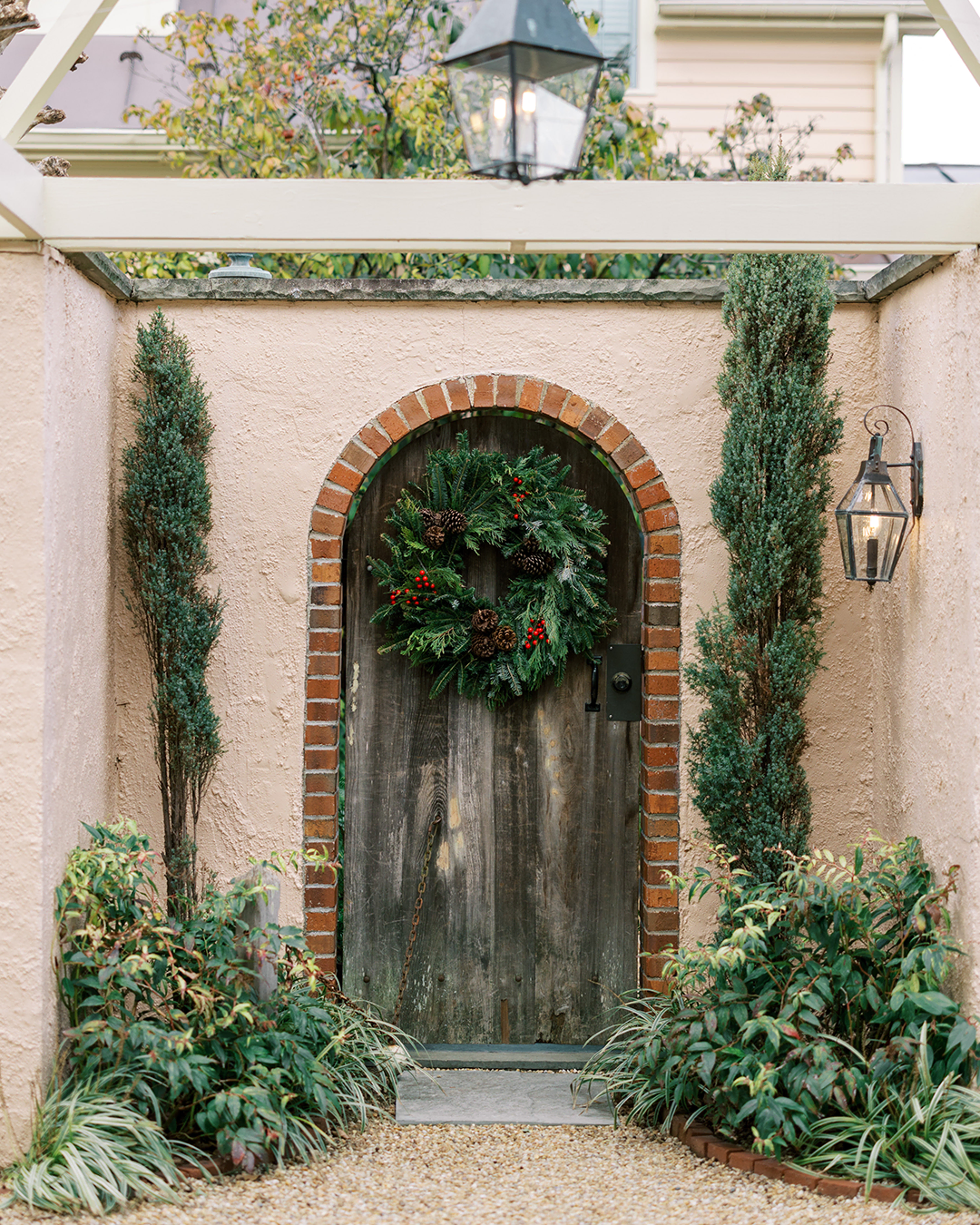 Rustic wooden door with festive holiday wreath at The Red Fox Inn & Tavern.
