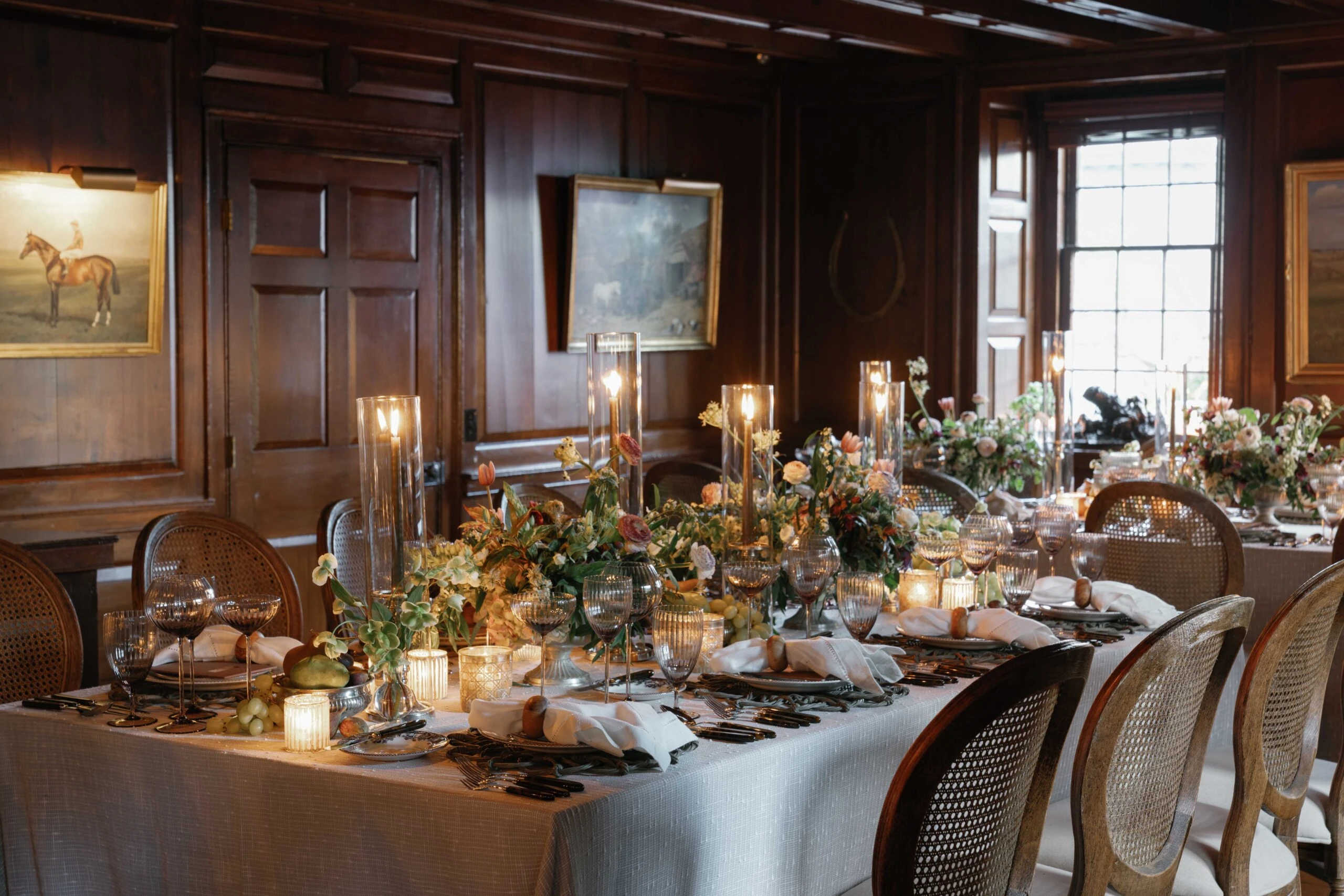 Elegant interior of The Red Fox Inn & Tavern with wooden paneling and floral table centerpiece.