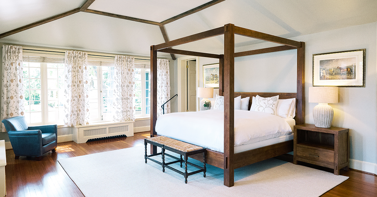 Elegant bedroom at The Red Fox Inn & Tavern with a four-poster bed and cozy decor.