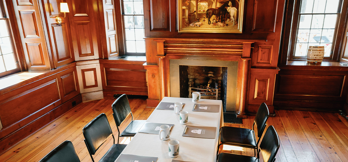 Elegant private dining room with wood paneling and fireplace at The Red Fox Inn & Tavern.