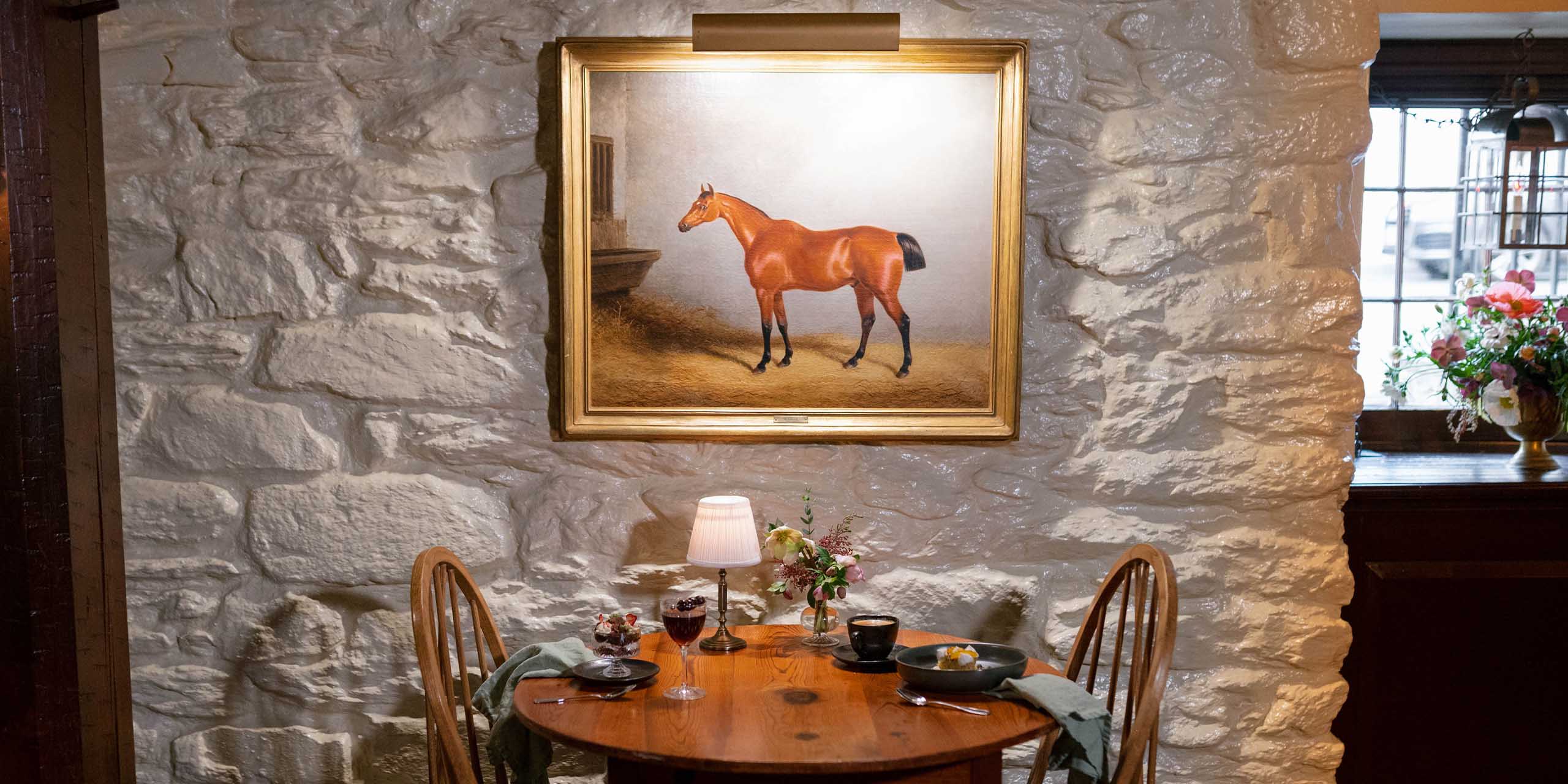 Historic inn and tavern in Middleburg, VA with rustic interior and artwork.