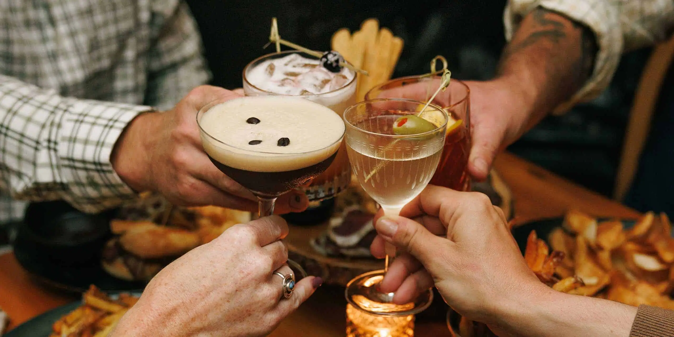 A group toasting with craft cocktails and beers at The Red Fox Inn & Tavern, a historic inn and tave.