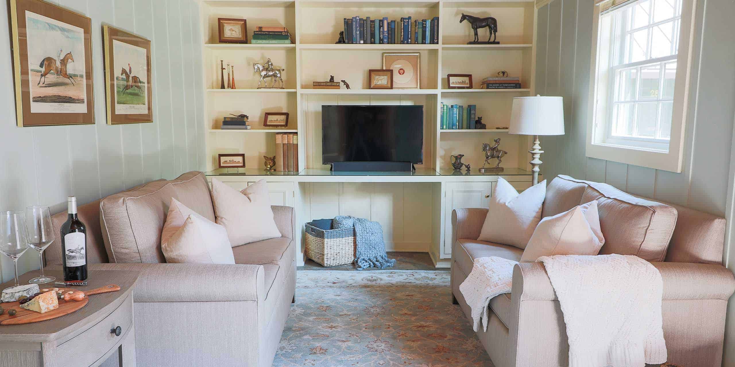 A cozy lounge area inside The Red Fox Inn & Tavern, featuring comfortable sofas, bookshelves, and a.