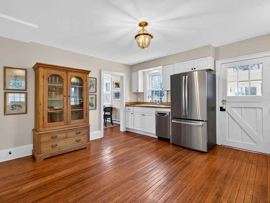 Cozy kitchen with white cabinets and stainless steel appliances.