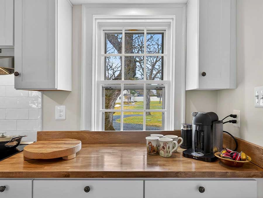 Bright kitchen window overlooking outdoor scenery.