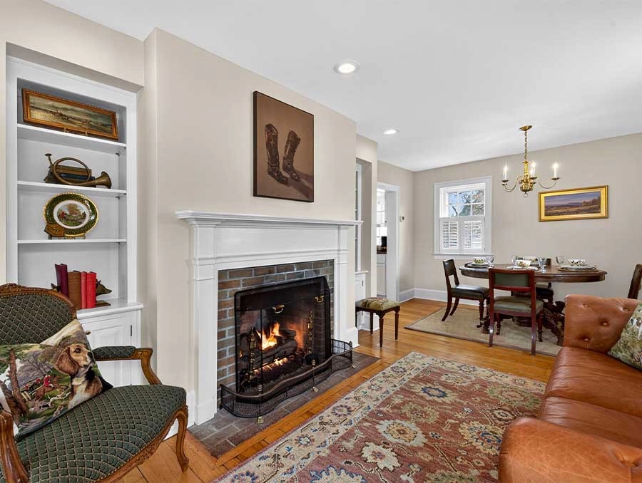 Charming living room with fireplace, classic furniture, and elegant decor at The Red Fox Inn & Taver.