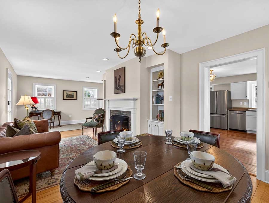 Elegant dining room with a round table, chandelier, and cozy living space in Huntland Huntboxes.