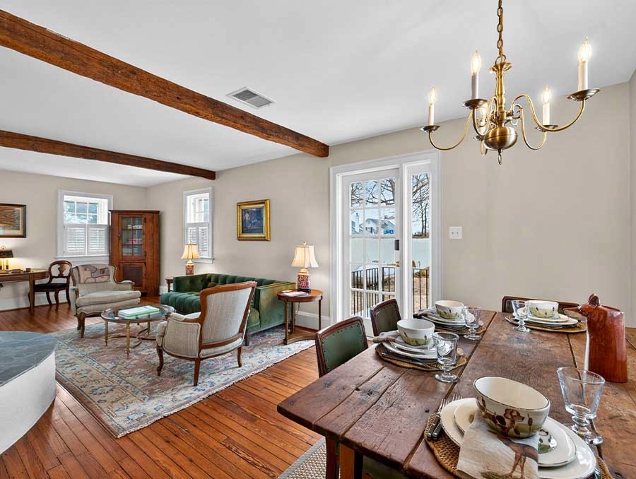 Charming living room with vintage furniture, hardwood floors, and natural light at The Red Fox Inn &.