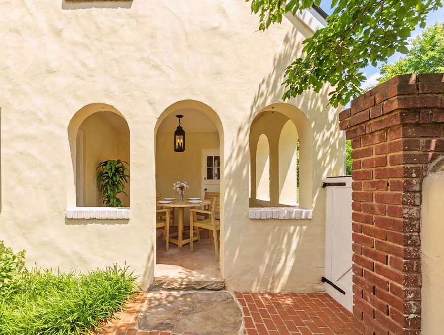 Charming entrance with arches at The Red Fox Inn & Tavern, showcasing inviting outdoor seating and c.