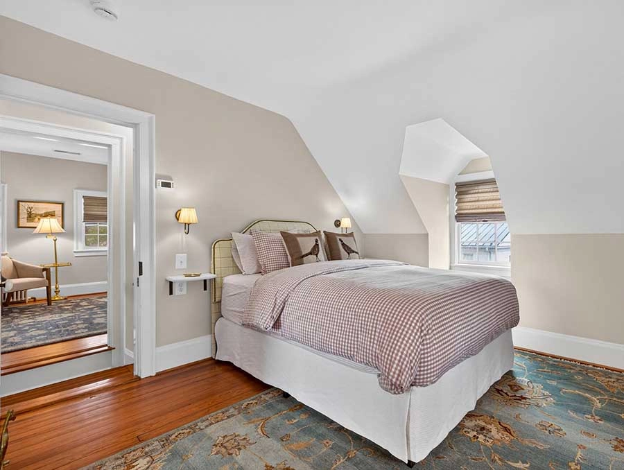 Cozy Cedar Cottage bedroom with a comfortable bed and natural light. Perfect for relaxing stays at T.
