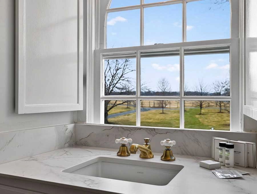 Bright kitchen window overlooking scenic outdoor landscape.