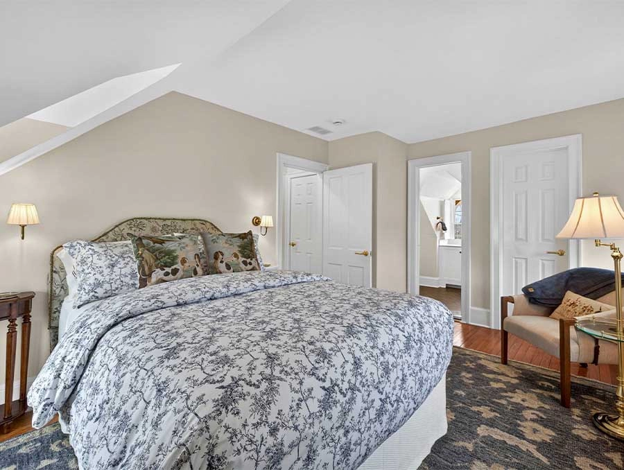 Comfortable bedroom with elegant bedding and natural light at Azalea Cottage.