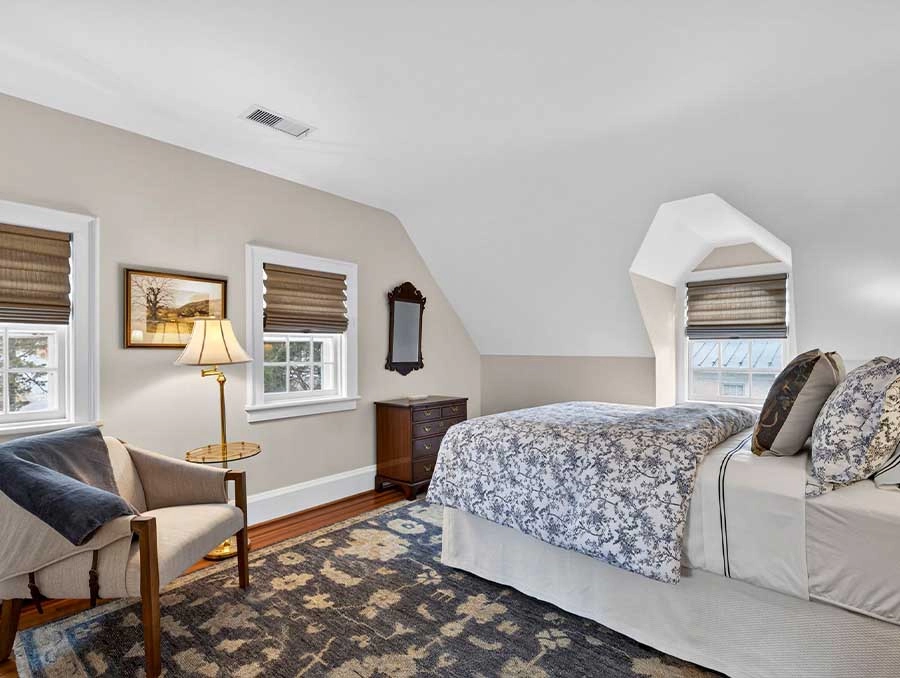 Comfortable bedroom with a large bed, cozy decor, and natural light at The Red Fox Inn & Tavern.
