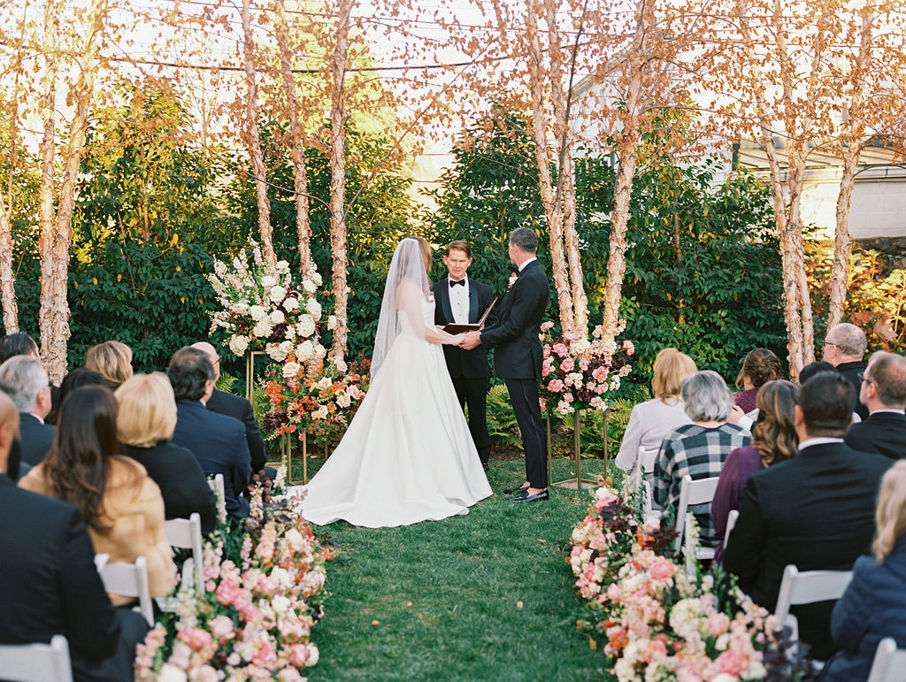 Wedding Ceremony at The Red Fox Inn & Tavern, Press event outdoors. Outdoor wedding ceremony with bride and groom exchanging vows at The Red Fox Inn & Tavern.