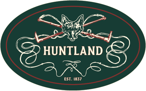 A cozy logo featuring a fox head with crossed hockey sticks and the text "Huntland" established in 1.