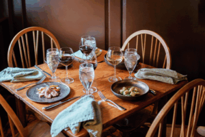 Elegant dining table set with wine glasses and plates at The Red Fox Inn & Tavern.